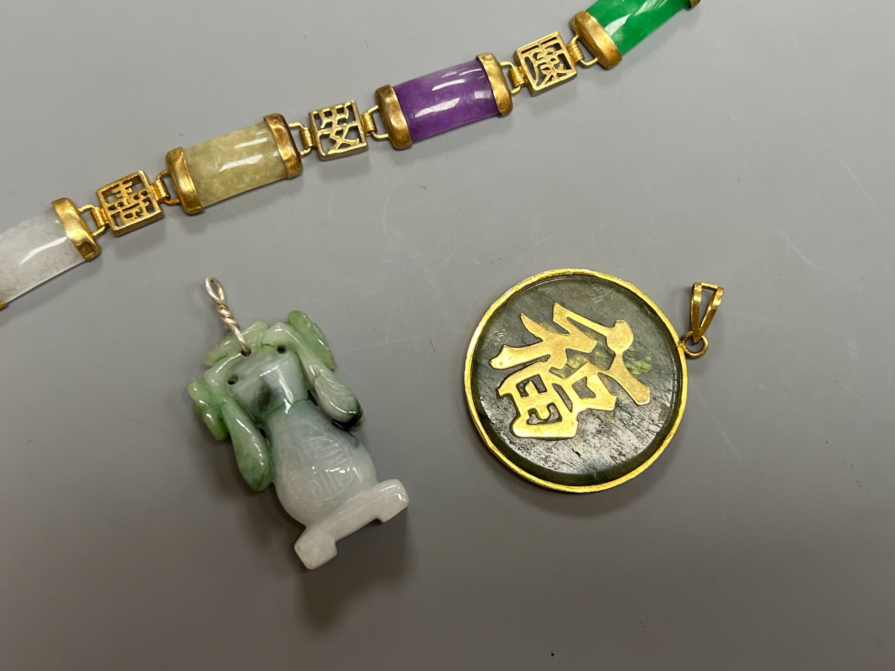 A Chinese multi coloured jadeite bracelet, and two jadeite pendants